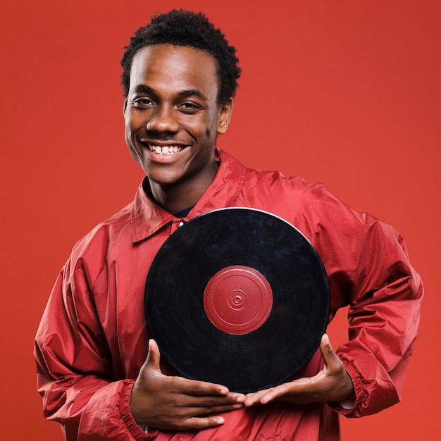 Free photo black man posing with vinyls