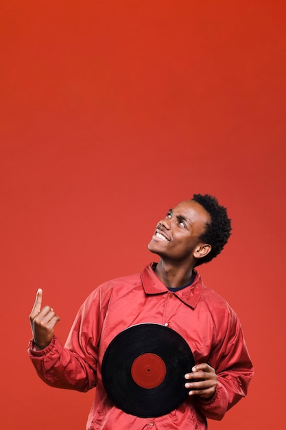 Black man posing with vinyls