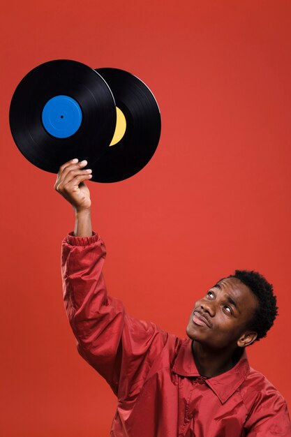 Black man posing with vinyls