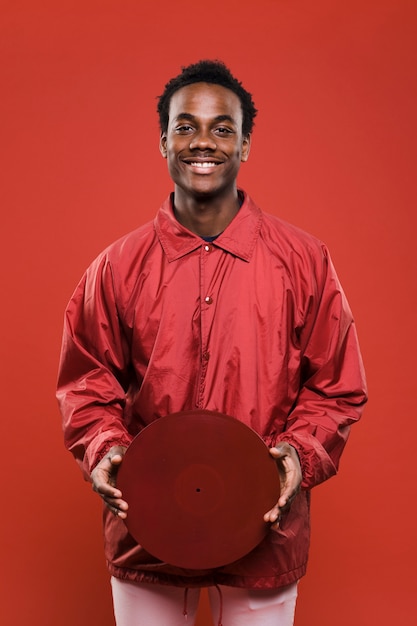 Free photo black man posing with vinyls