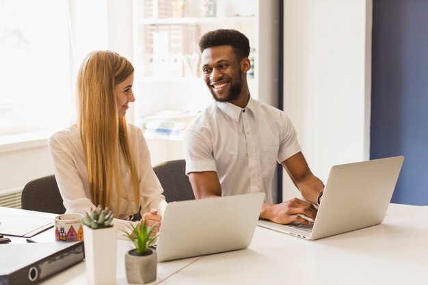Black man smiling to female colleague