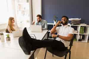 Free photo black man speaking on phone in office