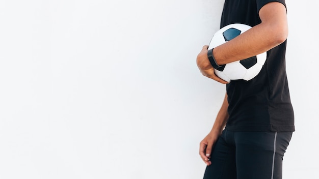 Free photo black man in sport clothes with soccer ball