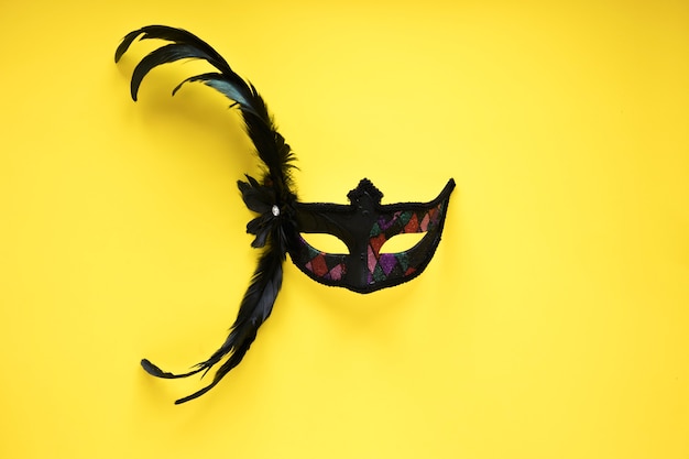 Free photo black mask on yellow