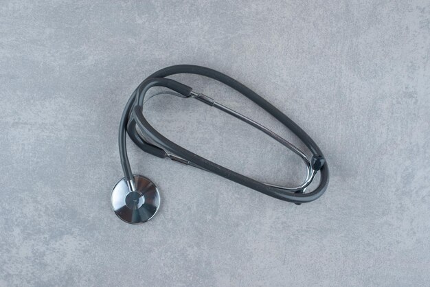 Black medical stethoscope on gray