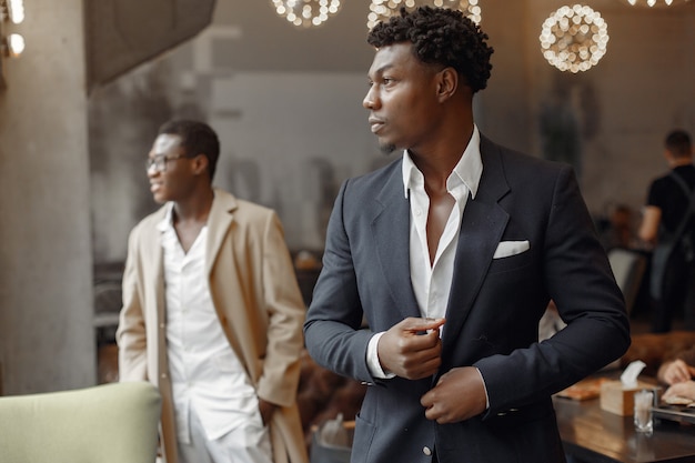 Black men in a cafe have a business