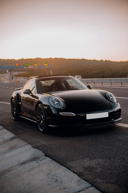 Black mini coupe on the road.