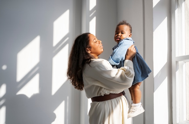 Free photo black mother taking car of her child