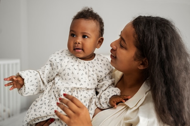 Free photo black mother taking car of her child