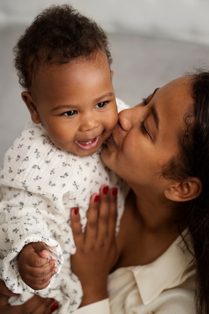 black mother taking car of her child