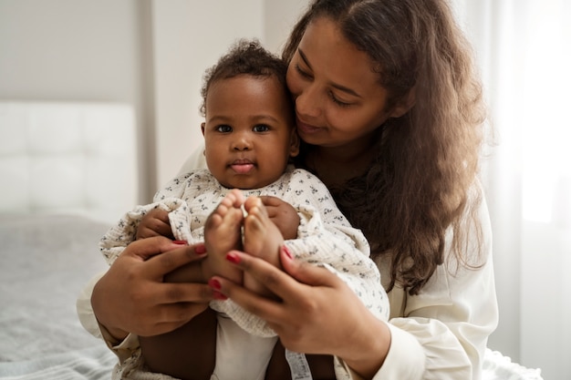 Free photo black mother taking car of her child