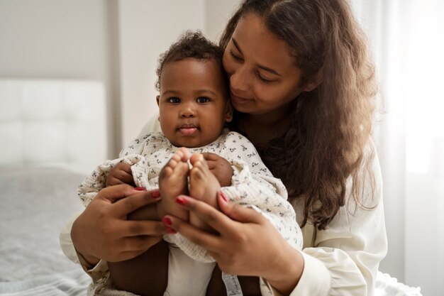 black mother taking car of her child
