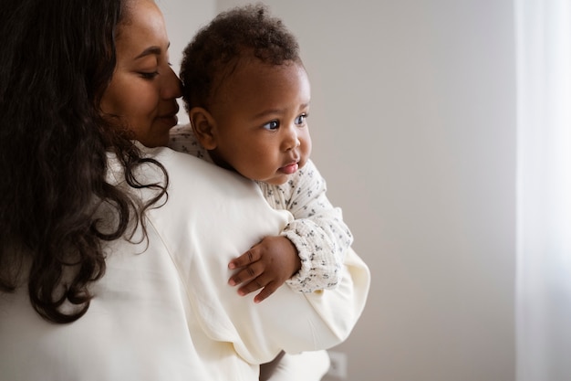 black mother taking car of her child