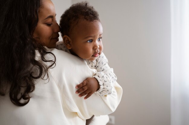 Black mother taking car of her child