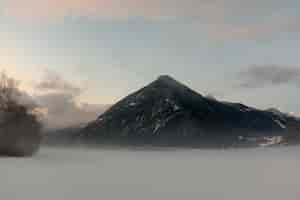 Free photo black mountain under cloudy sky