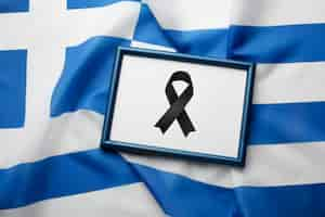 Free photo black mourning ribbon with greece flag