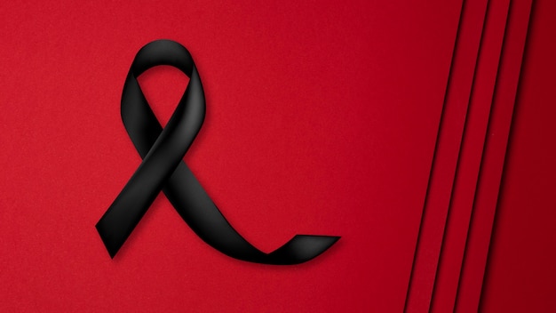 Free photo black mourning ribbon with red background