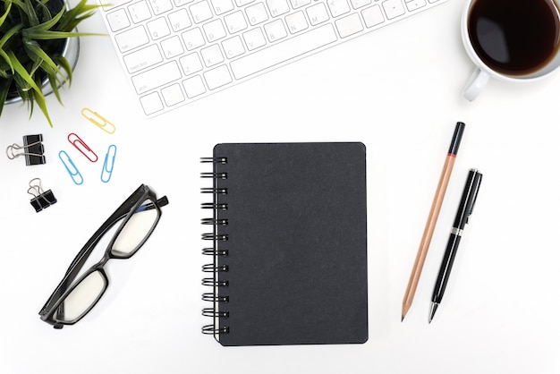 Black notebook on white desk table background with copy space