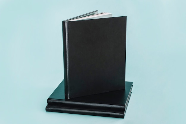 Free photo black notepad on stack on notebooks