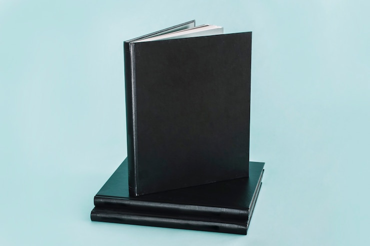 Free Photo black notepad on stack on notebooks