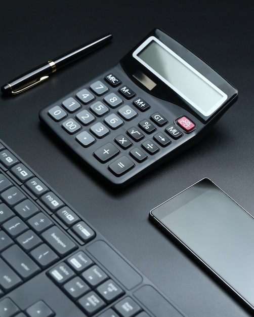 black office business equipment on black background