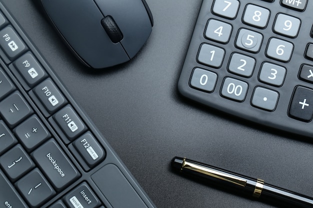 black office business equipment on black background