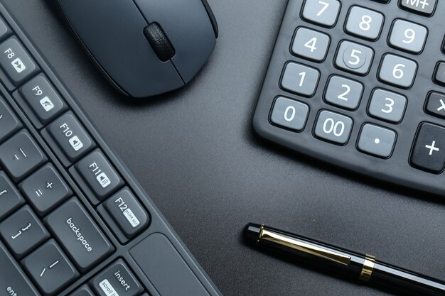 black office business equipment on black background