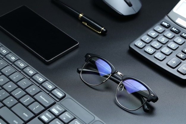 black office business equipment on black background