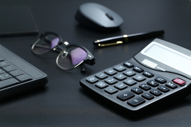 Black office business equipment on black background