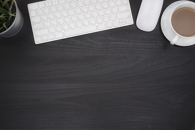 Black office desk table with computer and coffe cup