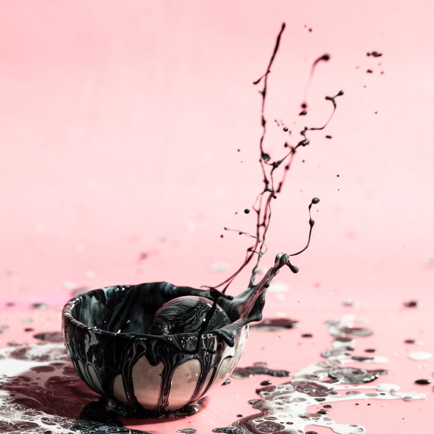 Black paint splash and cup abstract background