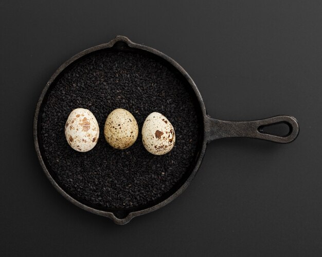 Black pan with poppy seeds and eggs