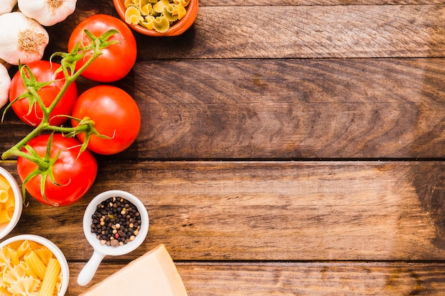 Black pepper near vegetables and pasta