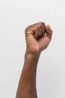 Free photo black person holding fist up