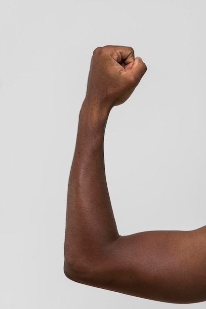 Black person holding fist up