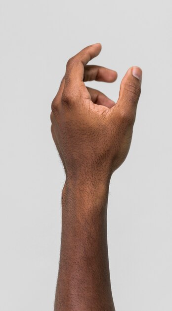 Black person holding hand up