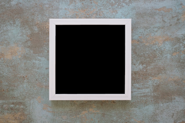 Free photo black picture frame on grunge wall