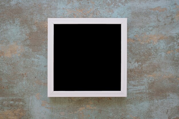 Black picture frame on grunge wall