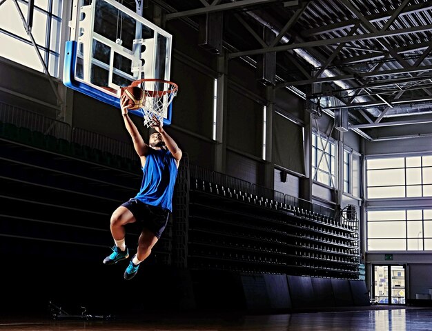 Black professional basketball player in action on a basketball field.