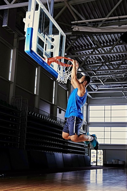 Free photo black professional basketball player in action on a basketball field.