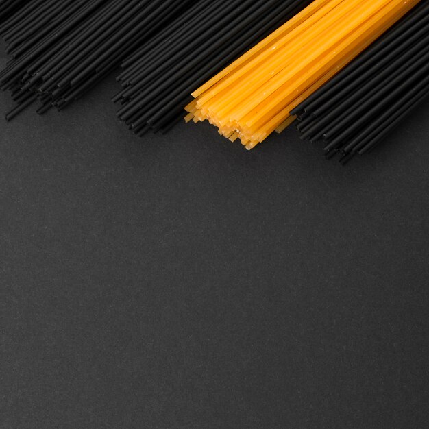 Black and regular pasta bundles with copy space