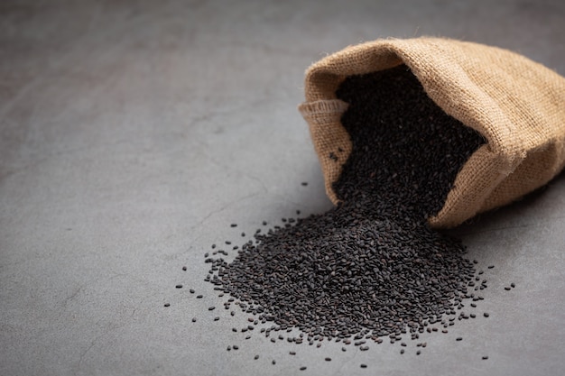 Free photo black sesame in the sack on dark background