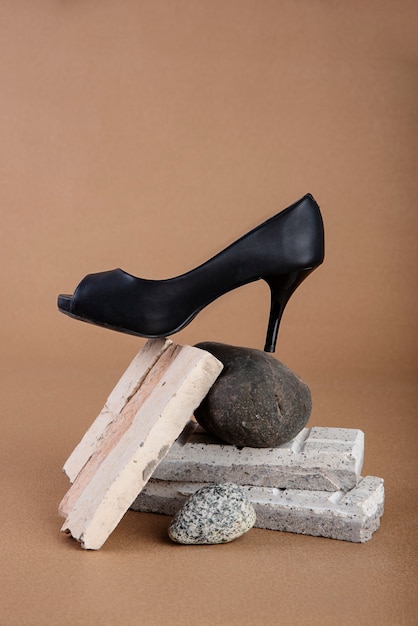 Free photo black shoe on rock in studio