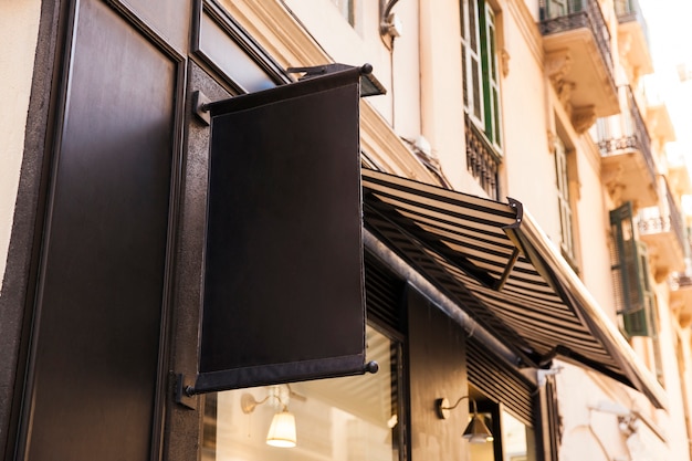 Black sign on house wall