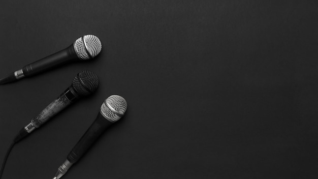 Free photo black and silver microphones on a black background