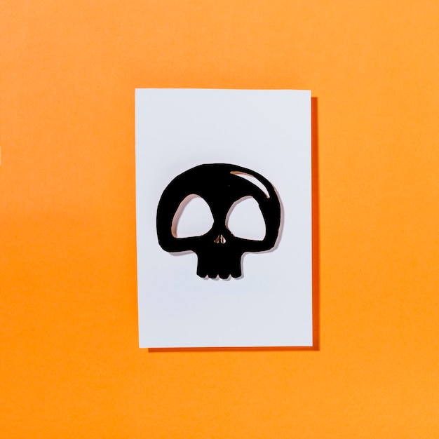 Free photo black skull on piece of white paper