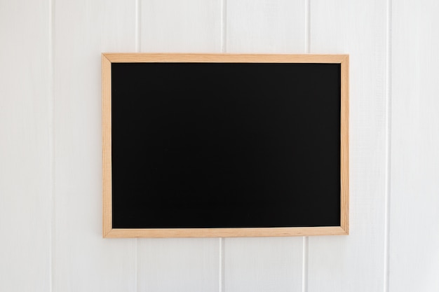 Free photo black slate on white wooden background