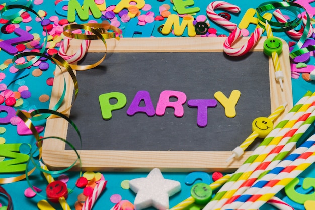 Black slate with confetti and letters where it puts "party"