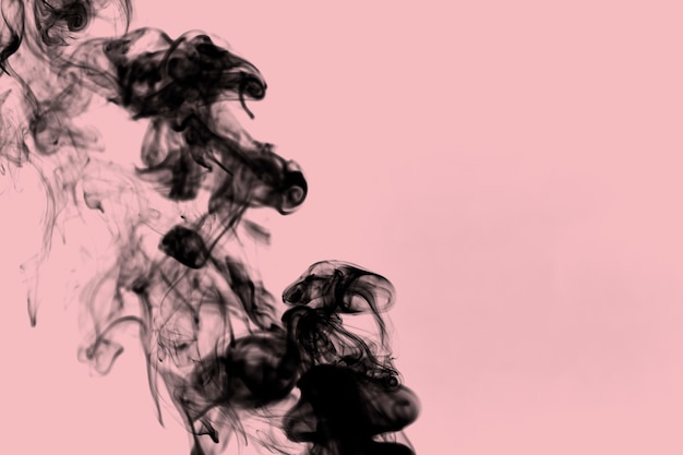 Free photo black smoke on pink background