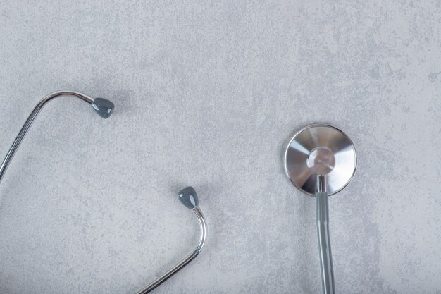 Black stethoscope isolated on gray surface